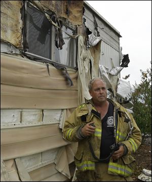 A Napa firefighter inspects mobile homes that were destroyed at the Napa Valley Mobile Home Park, in Napa, Calif. A gas fire destroyed four homes at the park after an earthquake struck California's northern San Francisco Bay area early Sunday morning.