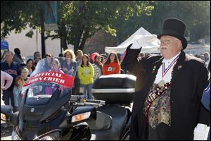 Sylvania town crier Michael Lieber salutes during the singing of the national anthem during last year's annual Fall Festival in Sylvania.