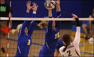 St. Ursula’s Stephanie Sylvester, left, and Elizabeth Coil attempt to block a shot by Perryburg’s Savannah Miller.