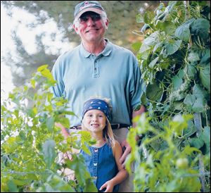 Elly and her grandfather Jim Krotzer in his garden in Gibsonburg.
