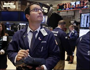 Trader Leon Montana works on the floor of the New York Stock Exchange. U.S. stocks opened slightly higher on Tuesday and remained in positive territory as economic reports touted a rise in consumer confidence, an increase in durable goods orders, and a rise, though slower, in U.S. home prices.
