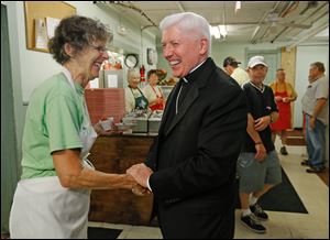 CTY 1stbishopvisit27p    Jean Scott, of Tontogany, left, with Bishop Daniel Thomas at the soup kitchen of Helping Hands of St. Louis. The Bishop and she had served lunch guests together.     Bishop Daniel Thomas visits Helping Hands of St. Louis Outreach Center in east Toledo, Ohio on August 26, 2014. Pope Francis named the Most Reverend Daniel E. Thomas as the eighth Bishop of the Roman Catholic Diocese of Toledo in America. He has been serving as an Auxiliary Bishop of the Archdiocese of Philadelphia. Helping Hands of St. Louis Outreach Center, located at 443 Sixth St., Toledo, Ohio, serves low income and homeless families and individuals.  The outreach center includes a soup kitchen, food pantry and clothing center.  Additional services include hygiene products, homeless kits and hot showers.   The Blade/Jetta Fraser