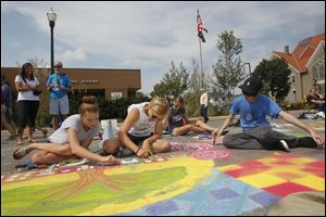 Eastwood High School art students compete in last year’s chalk art contest at the Black Swamp Arts Festival in downtown Bowling Green. 