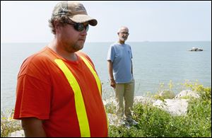 Kyle Davis, environmental services manager, left, and Wayne Miller, chief administrative officer of Pelee Island, stand outside the West Shore Treatment Plant during a water alert on the island, a southern tip of Canada.