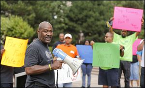 Anthony Garland, representative for Amalgamated Transit Union, speaks during a public transit rally in downtown Toledo.