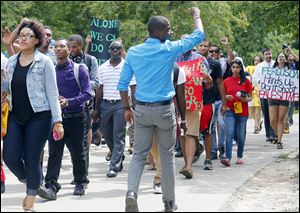 Robert Delk, president of the University of Toledo’s Black Student Union, leads a march on the University of Toledo campus commemorating the 51st anniversary  of the March on Washington.