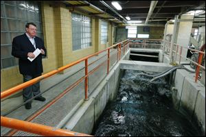 Warren Henry, the new program manager for water-plant upgrades, watches as water enters the chemical feed room at the Collins Park Water Treatment Plant.
