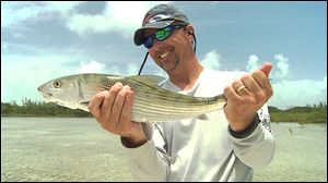 Ohio State football coach Urban Meyer with a bonefish he caught July 2013 while fishing in the flats of the Abacos Islands in the Bahamas.
