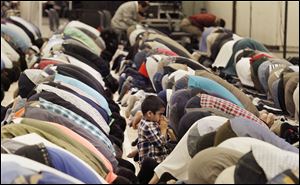 Worshippers bow for Asr, or afternoon prayer,  at the 51st annual Islamic Society of North America Convention at Cobo Center in Detroit. Former President Jimmy Carter is to present the keynote speech today. The convention concludes Monday.