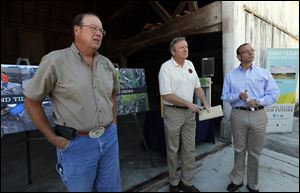 David Daniels, Ohio Department of Agriculture director, left, Jim Zehringer, ODNR director, and Craig Butler of the EPA, answer questions at a Wood County farm.