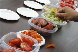 A visitor to the University of Wisconsin research farm samples tomatoes Wednesday in Verona, Wis. University plant breeders are working with chefs and farmers to develop better-tasting vegetables.