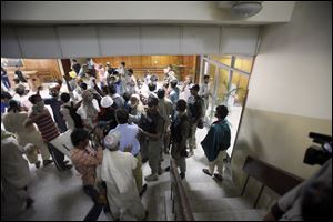 Pakistani paramilitary troops call on protesters to evacuate the state television building in Islamabad, Pakistan, today.