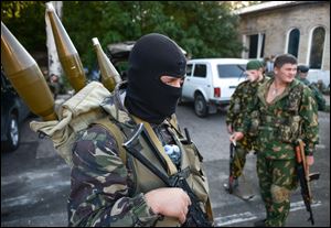 Pro-Russian rebels prepare arms for the the assault on the positions of Ukrainian army in Donetsk airport, eastern Ukraine, Sunday.