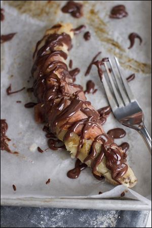 Chocolate peanut butter coated grilled bananas.