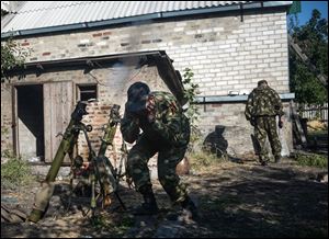 Pro-Russian rebels lead suppressive fire at the positions of Ukrainian army, during shelling in Donetsk, eastern Ukraine, today.