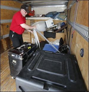 John Gunther secures band instruments into a van at the Oregon police station in Oregon, Ohio. His band Euro Express had its equipment stolen at the German American fest and he received most of it back today.