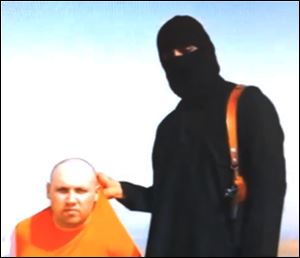 In this image from an undated video released by Islamic State militants Tuesday, purports to show journalist Steven Sotloff being held by the militant group. 