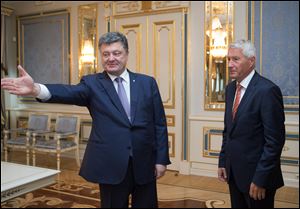 Ukrainian President Petro Poroshenko,  left, welcomes Secretary-General of the Council of Europe Thorbjorn Jagland during a meeting in Kiev, Ukraine, Monday.