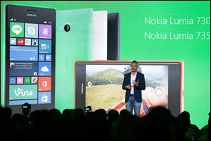 Chris Weber, CVP, Mobile Devices Sales of Microsoft  presents the new Lumia 730 and 735 smart phones during his keynote speech  at a Microsoft Nokia presentation event at the consumer electronic fair IFA in Berlin, today.