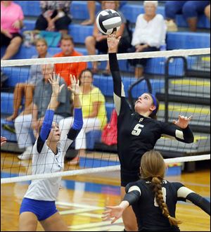 Perrysburg's Lauren Smith dinks the ball over the net against Anthony Wayne in Thursday night’s match.