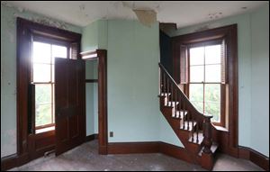 The third floor turret room features a staircase that leads up to another room and finally the roof. 
