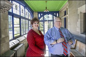 Realtors Geralyn Brock and Jon Modene, on the entry porch of the Tillinghast Willys Bell mansion, say the home has attracted several queries from out-of-state potential buyers.