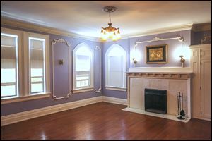 One of the nine bedrooms in the Tillinghast Willys Bell house. The home still has the original bathroom fixtures, a butler’s pantry, a third-floor ballroom, several stained-glass windows, and a huge formal dining room finished in chestnut. 