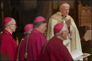 The Most Rev. Daniel Thomas, center, bows his head during an evening prayer service at Rosary Cathedral. Several hundred witnessed Bishop Thomas serve as celebrant and homilist for the evening service on Tuesday.