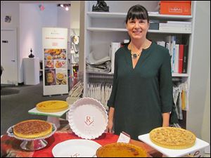 Susan Allan Block, owner of Vendome Pastry, offers samples of her French tarts prepared on Revol during the cookware trunk show at the Paula Brown Shop.