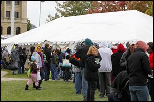 Patrons line up outside the clothing tent at Tent City at Civic Center Mall during the 2013 event.
