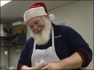 Rick Pawloski, the head baker at Michael's Cafe and Bakery, works on ...