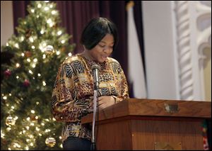 Above, Scott High student Tamarra Galloway speaks about Scott alum Navy Lt. William Buderus, who served aboard the USS Gambier Bay, during the second annual ‘Fallen War Heroes’ assembly during  which students  recounted stories of Toledoans who were killed in World War II.