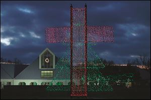 The Church on Strayer in Maumee erected a ‘Cross-mas Tree,’ a light display of a 30-feet-high red cross superimposed over a green tree outline. 