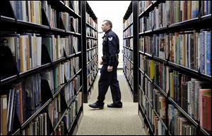 Security officer Mike Vascik patrols the Main Library, which has the most patrons and the greatest number of disturbances in the Toledo-Lucas County Public Library system.