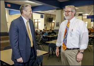 Perrysburg Schools Superintendent Thomas Hosler, left, chats with high school principal Michael Short at Perrysburg High School. ‘We value our staff and what they do and we try to show that, although we can never do a great enough job,’ Mr. Hosler says.