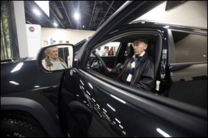Dick Corado and his wife, Nathalie, of Oregon examine a 2015 Jeep Cherokee at the Toledo Auto Show.