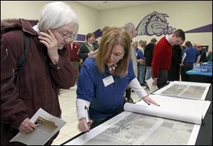 A  NEXUS representative shows a property owner a proposed study corridor map at a public forum at Swanton High School last week.