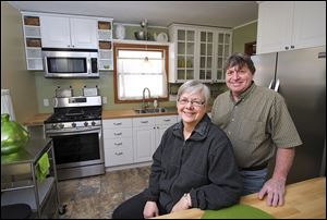 Leitha and Dick Sackmann show the kitchen they had renovated in the South Detroit Avenue house that they purchased from the Lucas County Land Bank. 