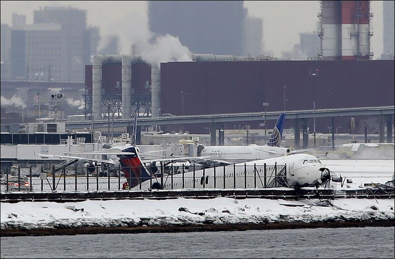 Plane skids off snowy runway at New York's LaGuardia Airport, stops