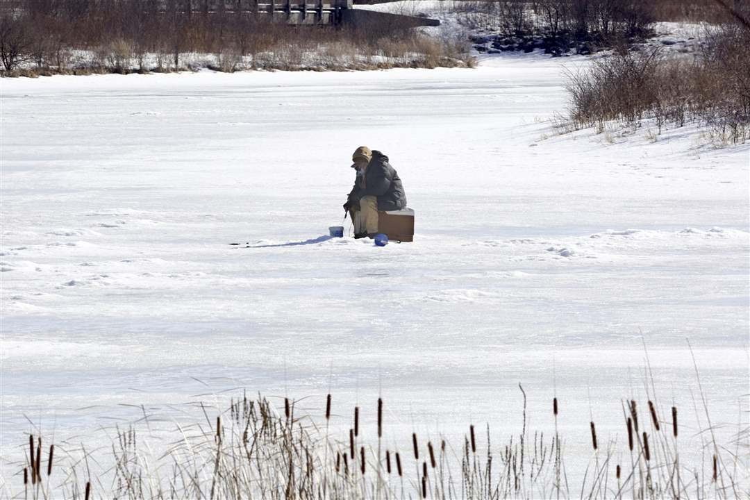 ROV-signsofspringAn-ice-fisherman-with-his-li