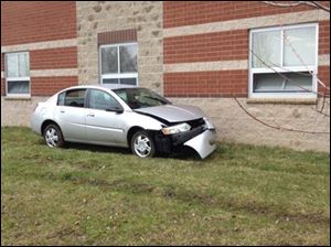 bowsher school strikes tree car sits damaged along vehicle building side after