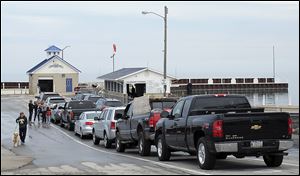 Vehicles wait to board a ferry from Catawba Island Township to South Bass Island.