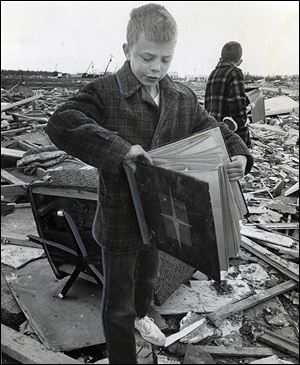 Donnie Kirchoff finds his scrapbook in the ruins of his family home in Toledo. He had pasted presidential portraits that appeared in The Blade in the scrapbook.