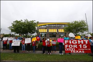 Fast-food workers outside a McDonald's protest for higher wages Thursday in Houston.