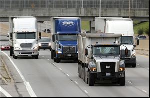 Tractor-trailers roll along I-75 in Detroit. If enacted, Michigan’s gasoline tax would increase from 19 cents per gallon to 41.7 cents per gallon. The tax on diesel would increase from 15 cents per gallon to 46.7 cents per gallon.