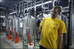  Assistant Brewer, senior chemistry major Stephen Moser, 23, tastes a batch of freshly brewed beer at the recently opened Innovation Brew Works at the California State Polytechnic University.