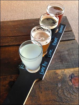A flight of summer beers: Key Lime Pie Flora radler, County Line honey braggot, Joe E. Brown S’Mores stout, and Taylor’s Harbor mango IPA from Flatrock Brewing Co.