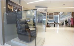 A modern La-Z-Boy chair is encased in glass at the entrance of the La-Z-Boy headquarters. 
