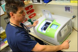 Dentist Rick Rivardo operates a Plan Mill milling unit at his office in Monroeville, Pa.
