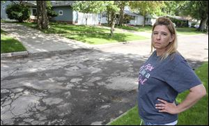 Patty Hindall, a resident of Clover Lane in West Toledo for 14 years, says her husband often calls the city about potholes. Patch crews recently needed to repair cracks and potholes that were forming where some driveways met the street, but she says she would like to see her street completely resurfaced.